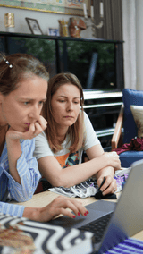 Founder Anaïs Lombard and MD Adeline de Boismenu concentrate at a laptop screen working on a project together