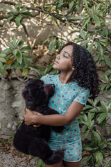 Sensory-friendly short pyjamas for kids in aqua blue with a playful fruit print. Tag-free V-neck and breathable fabric for all-night comfort.