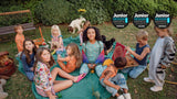 Kids having a picnic eating pizza with Junior Design Awards logos.