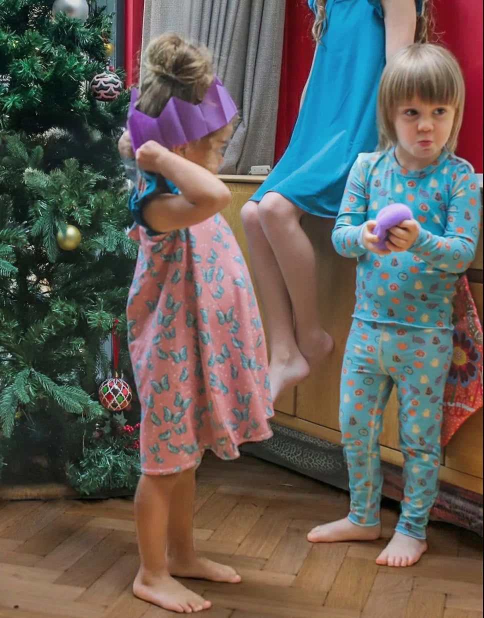 boy and girl wearing soft sensory friendly pyjamas at Christmas. The boy has a squishy toy in his hands