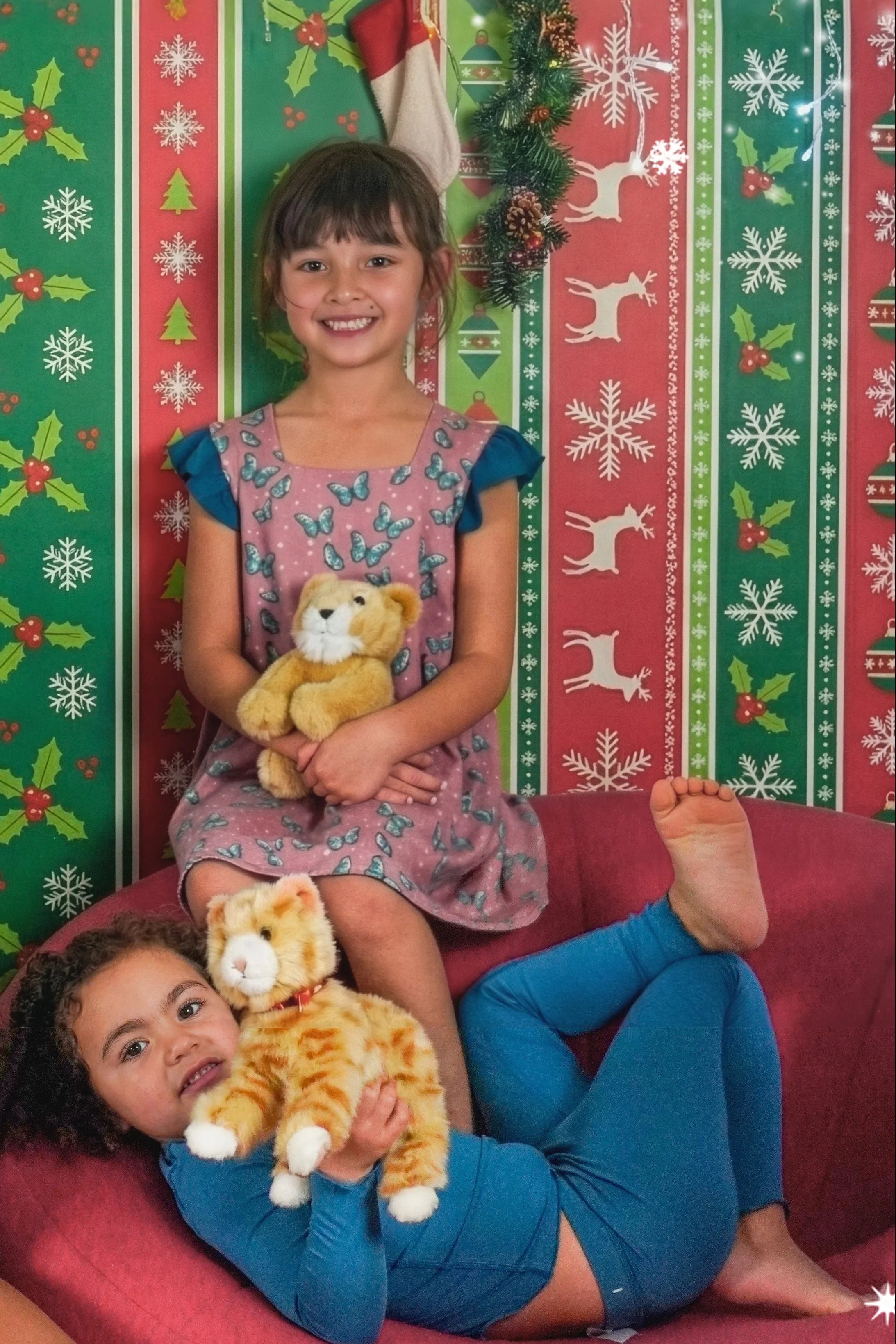 two girls with teddy bears wearing a pink dress with butterfly and a soft blue pyjamas